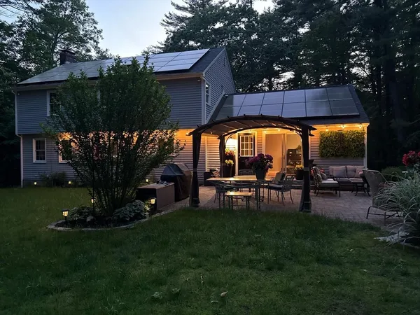 a view of a chairs and table in backyard of the house