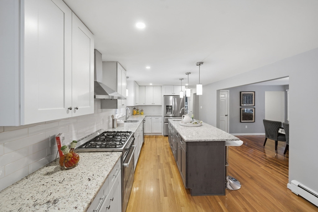 40 Curtis Road Boxford, MA 01921 - Photo 6 of 34 a kitchen with stainless steel appliances granite countertop a sink stove and refrigerator