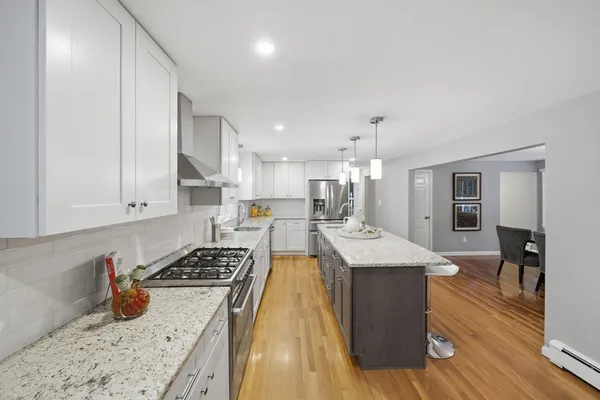 a kitchen with stainless steel appliances granite countertop a sink stove and refrigerator