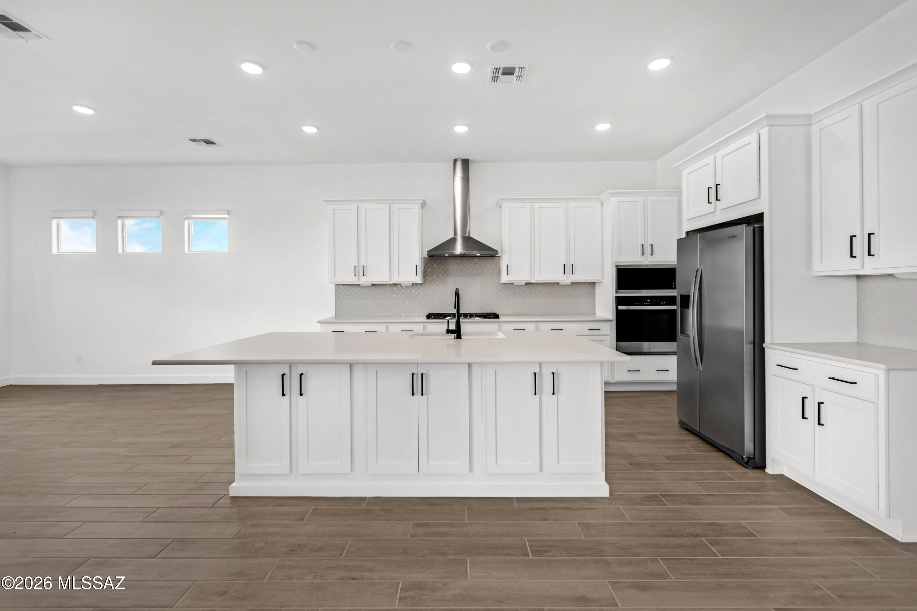 14736 East Sands Ranch Road Vail, AZ 85641 - Photo 11 of 20 a kitchen with stainless steel appliances a refrigerator sink and white cabinets