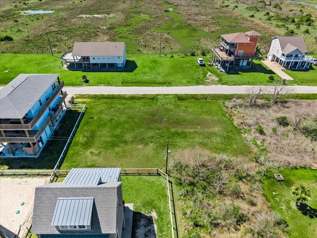 an aerial view of a tennis ground and a lake view