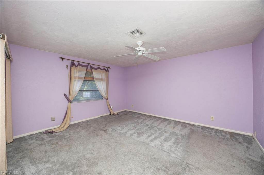 379 Torrey Pines Point Naples, FL 34113 - Photo 15 of 21 Carpeted flooring, ceiling fan, window, and textured ceiling