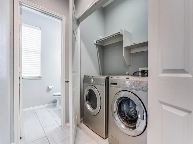 a view of a hallway with washer and dryer