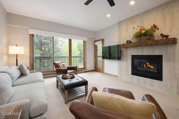 a living room with furniture fireplace and flat screen tv