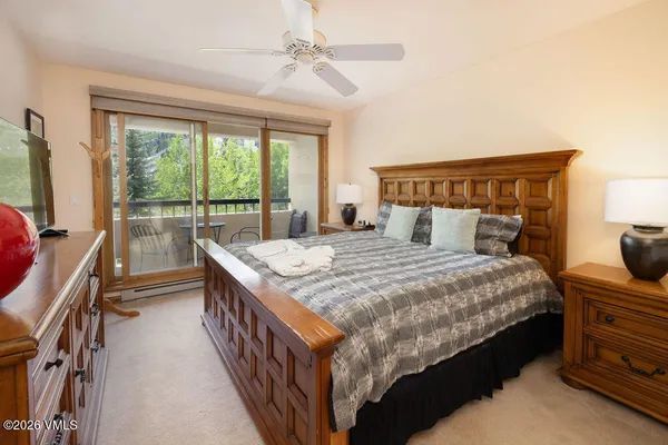 a bedroom with a bed and a large window with outer view