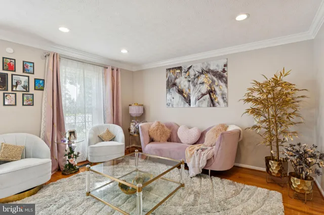 a living room with furniture and a large window with rug floor