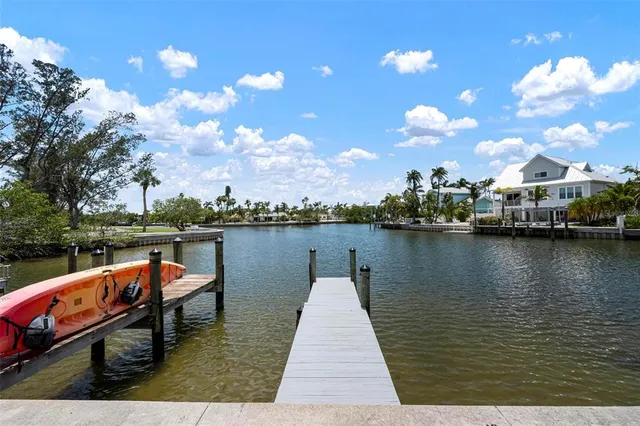 a backyard of a house with barbeque oven table and chairs