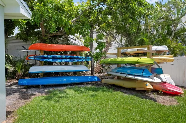 a view of a house with a yard and potted plants