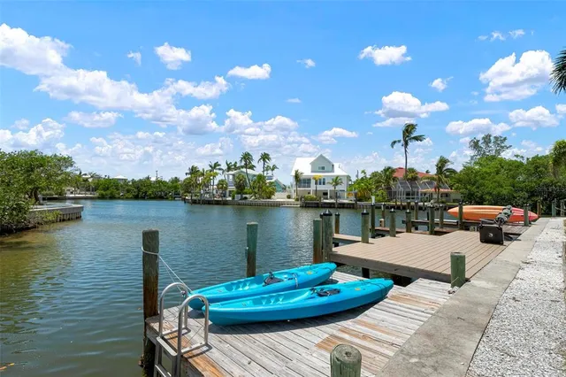 a view of a lake with couches chairs