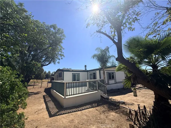a view of a roof deck with wooden fence and floor