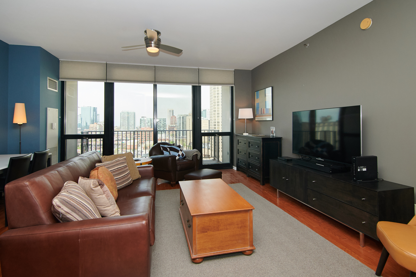 210 South Desplaines Street, Unit 1003 Chicago, IL 60661 - Photo 3 of 27 a living room with furniture and a flat screen tv
