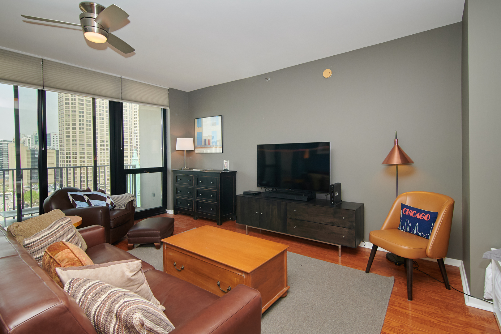210 South Desplaines Street, Unit 1003 Chicago, IL 60661 - Photo 4 of 27 a living room with furniture and a flat screen tv