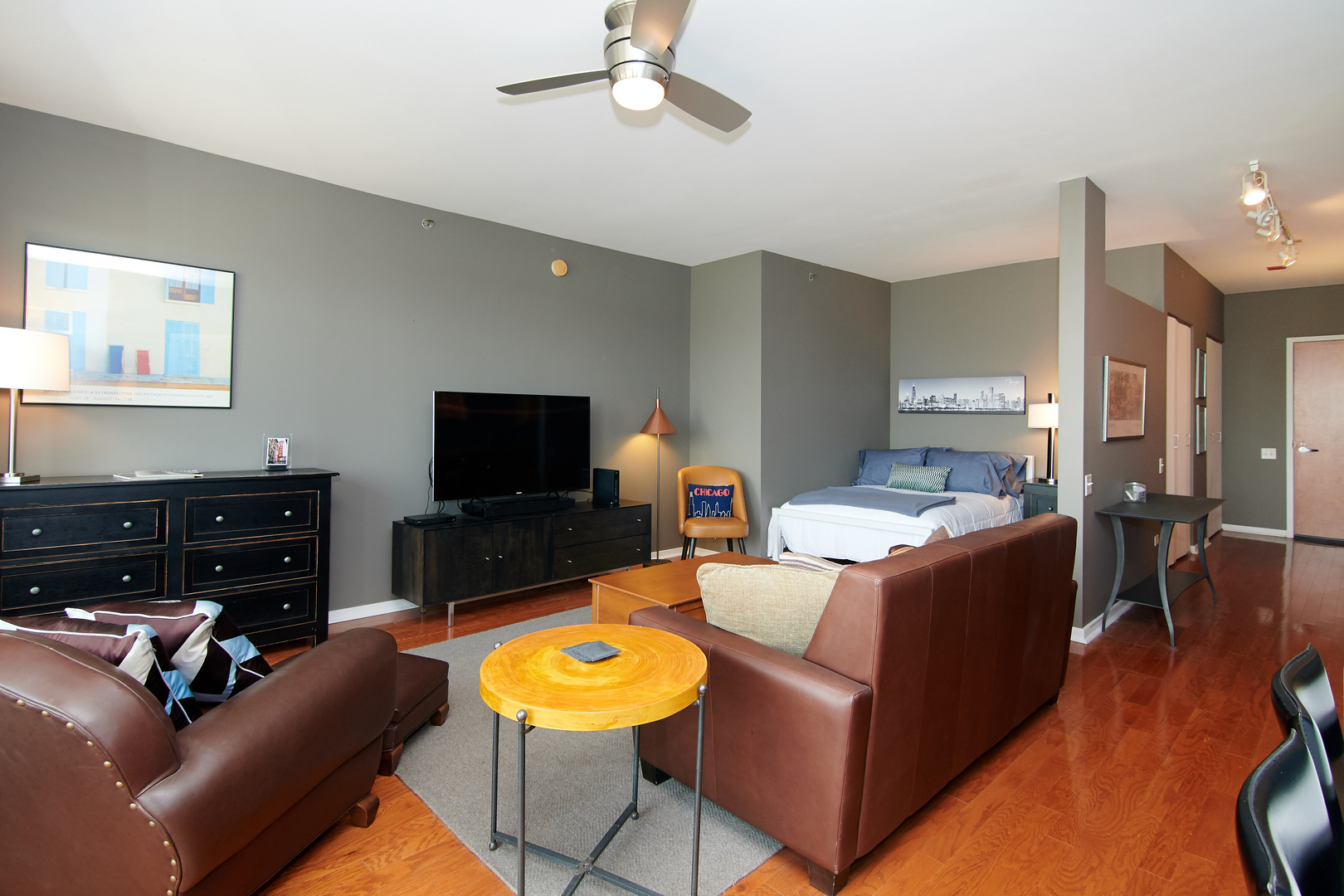 210 South Desplaines Street, Unit 1003 Chicago, IL 60661 - Photo 6 of 27 a living room with furniture and a flat screen tv