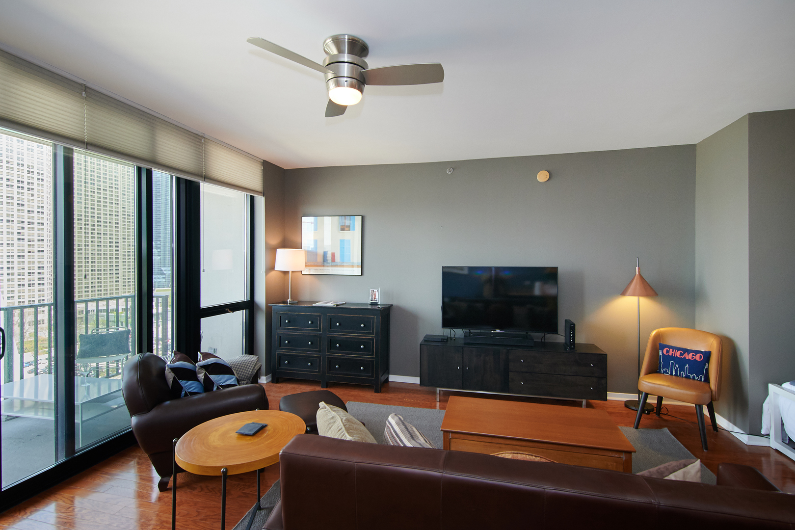 210 South Desplaines Street, Unit 1003 Chicago, IL 60661 - Photo 7 of 27 a living room with furniture and a flat screen tv