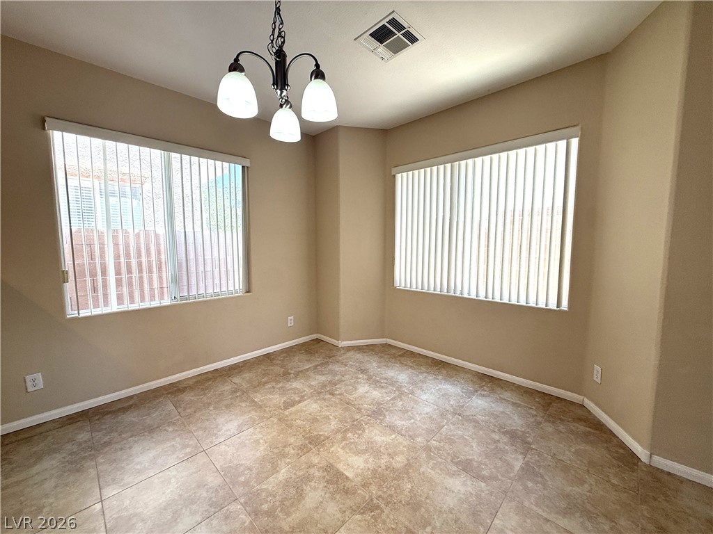 5942 Rampolla Drive Las Vegas, NV 89141 - Photo 5 of 27 A well-lit room featuring tile flooring and abundant natural light from large windows.