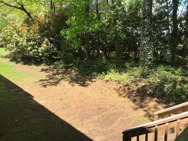 a view of a yard with wooden fence