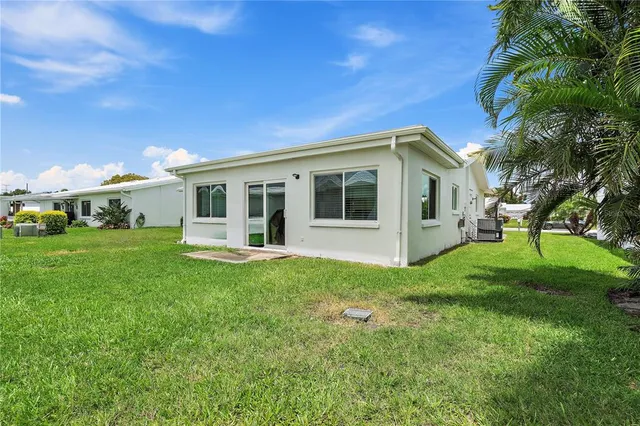 a view of a house with backyard porch and sitting area
