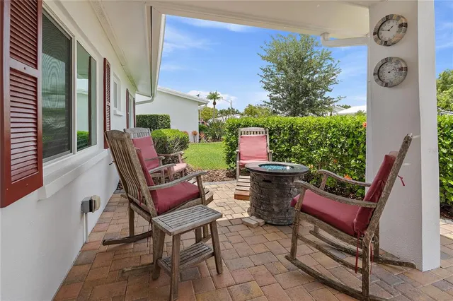 a building outdoor space with patio furniture and potted plants