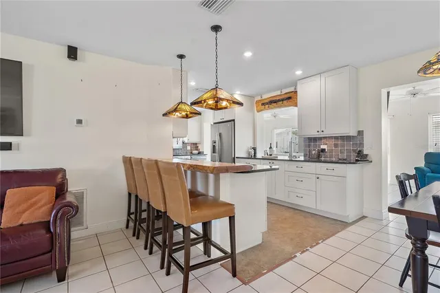 a kitchen with stainless steel appliances kitchen island granite countertop a sink and cabinets