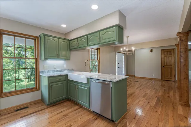 a view of a livingroom with wooden floor and a ceiling fan