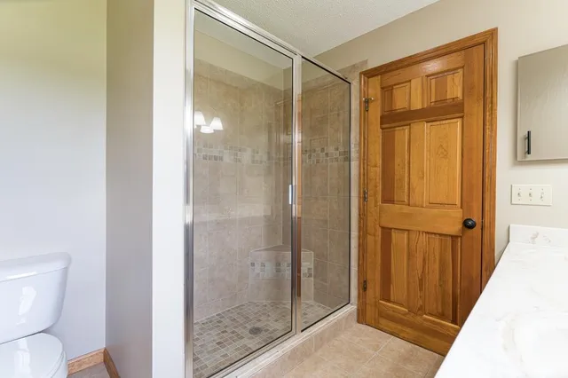 a view of a kitchen with a sink and a refrigerator in it