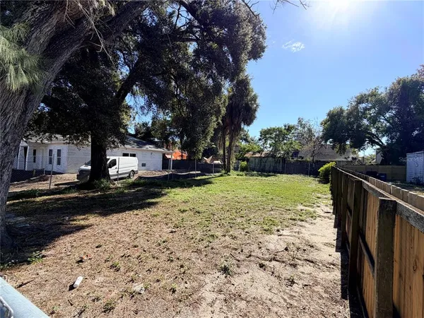 a view of a backyard with wooden fence