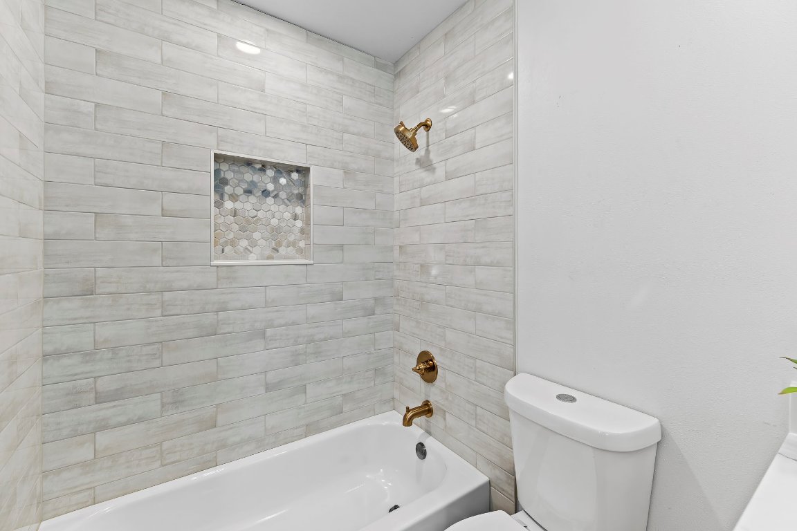7302 Hartnell Drive Austin, TX 78723 - Photo 17 of 23 a bathroom with a bathtub and a toilet