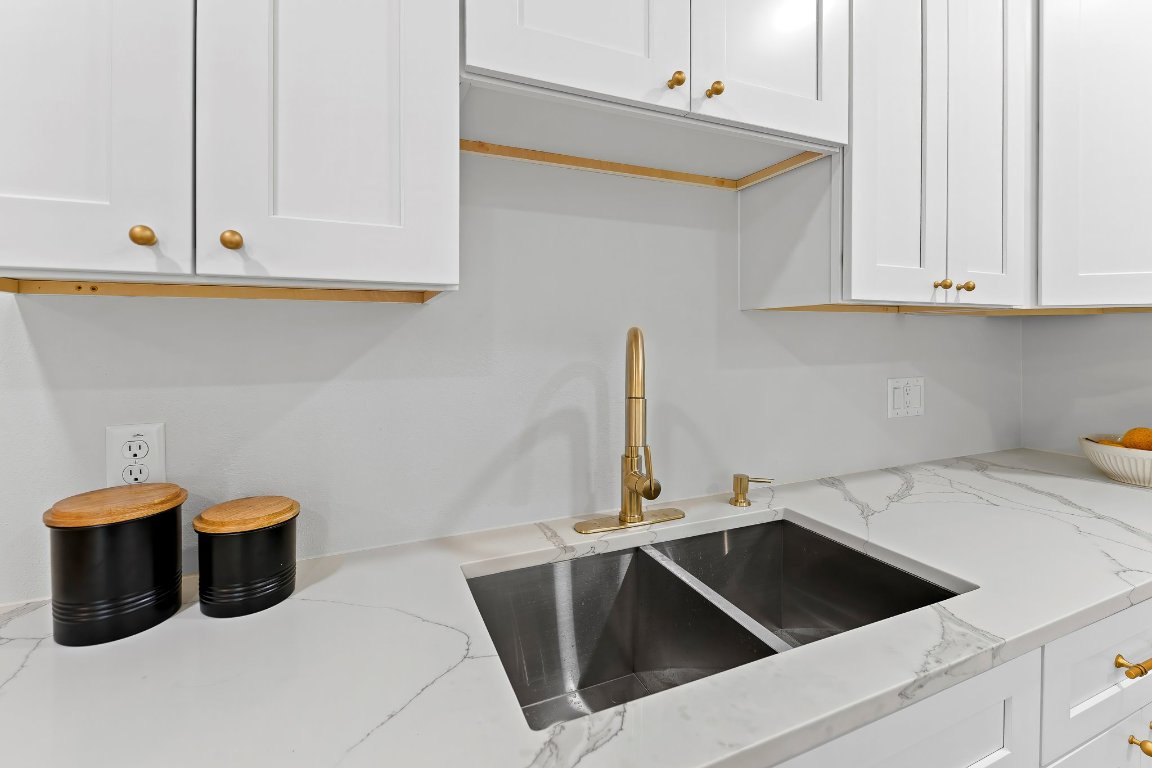 7302 Hartnell Drive Austin, TX 78723 - Photo 7 of 23 a kitchen with a sink and a cabinets