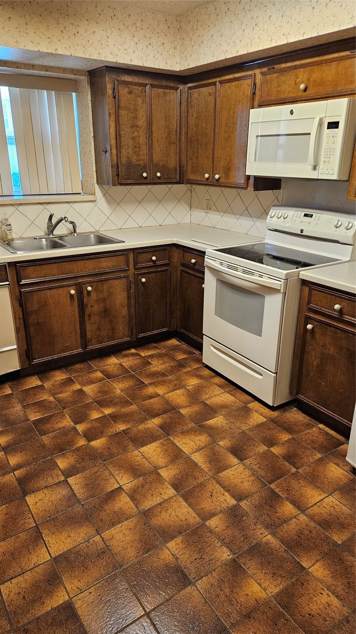 5607 Innsbruck Street Bellaire, TX 77401 - Photo 2 of 11 a kitchen with a stove a sink and a microwave