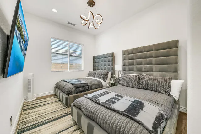 a bedroom with two beds and a window