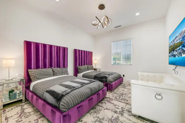 a bedroom with a bed and a chandelier