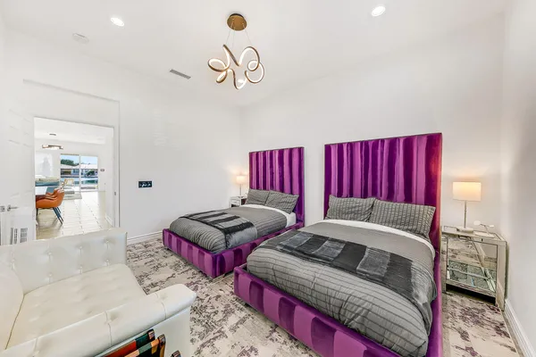 a bedroom with furniture and a mirror
