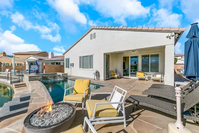 a view of a patio with table and chairs with wooden floor and fence