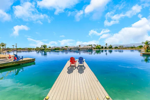 a lake view with a large trees in the background