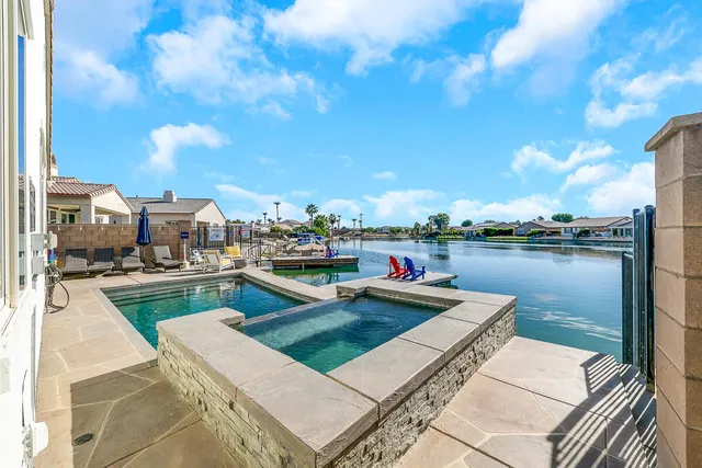 a view of a lake with couches chairs