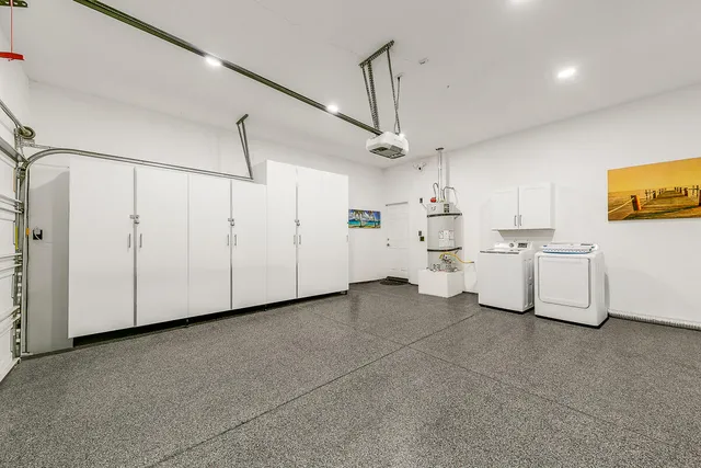 a view of a kitchen with white cabinets and white appliances