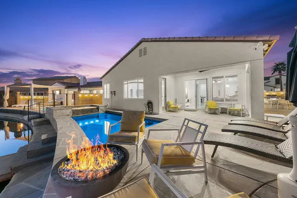 a view of a house with swimming pool and sitting area
