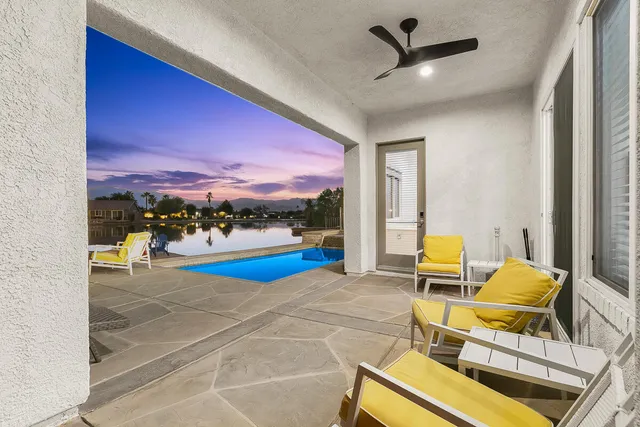 a view of a livingroom with furniture and a floor to ceiling window