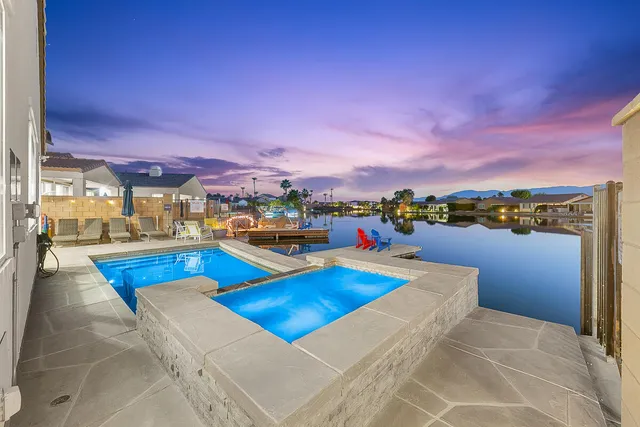a view of a swimming pool with a lounge chairs