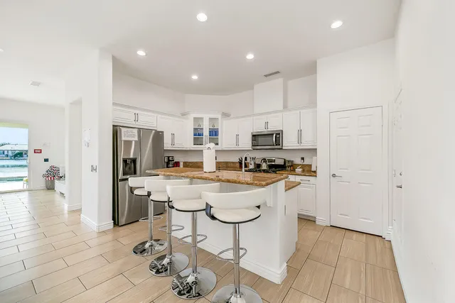 a kitchen with stainless steel appliances a refrigerator stove microwave and cabinets