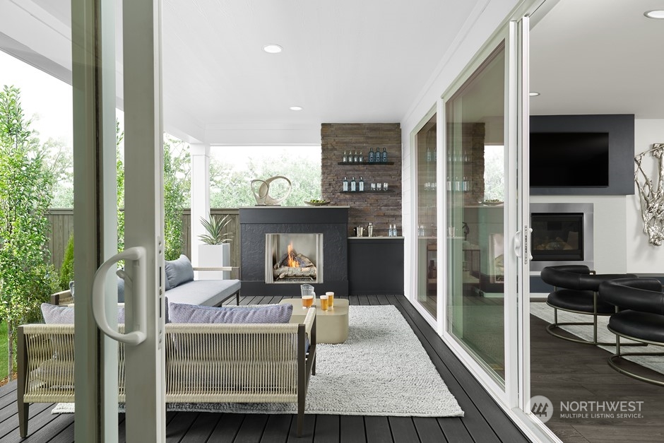 6551 Southeast 8th Street Renton, WA 98059 - Photo 8 of 11 a living room with furniture a flat screen tv and a fireplace