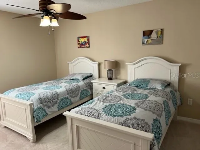 a bedroom with a bed and ceiling fan
