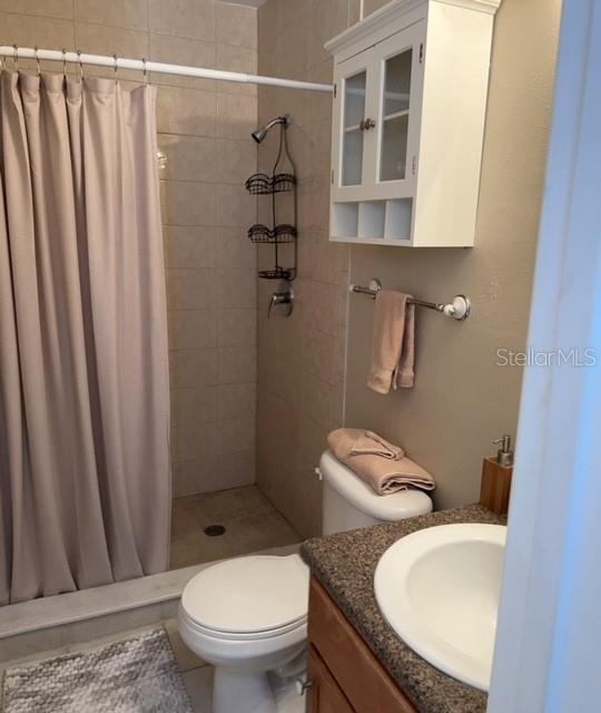 1818 Parakeet Way, Unit 1001 Sarasota, FL 34232 - Photo 17 of 21 a bathroom with a granite countertop toilet and a sink