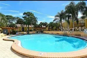 a swimming pool with outdoor seating and yard
