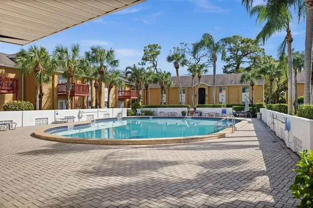 a view of a house with a yard and potted plants