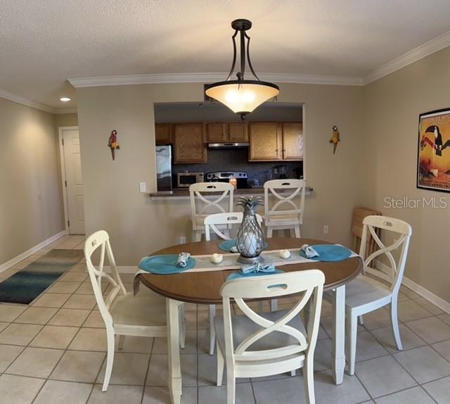 1818 Parakeet Way, Unit 1001 Sarasota, FL 34232 - Photo 7 of 21 a dining room with furniture and window