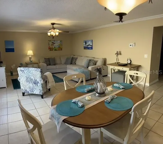 a living room with lots of furniture and a chandelier