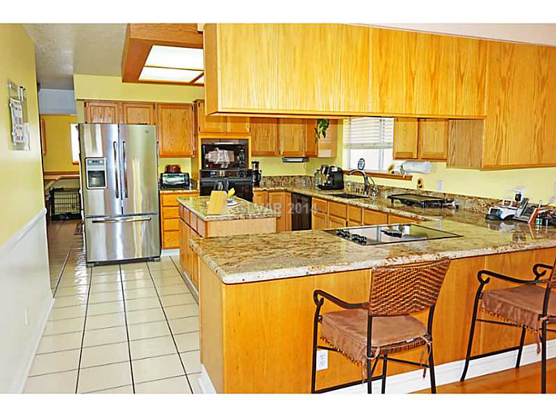 2051 Thoroughbred Road Henderson, NV 89002 - Photo 8 of 32 Property Photo. Upgraded kitchen with granite counters and breakfast bar