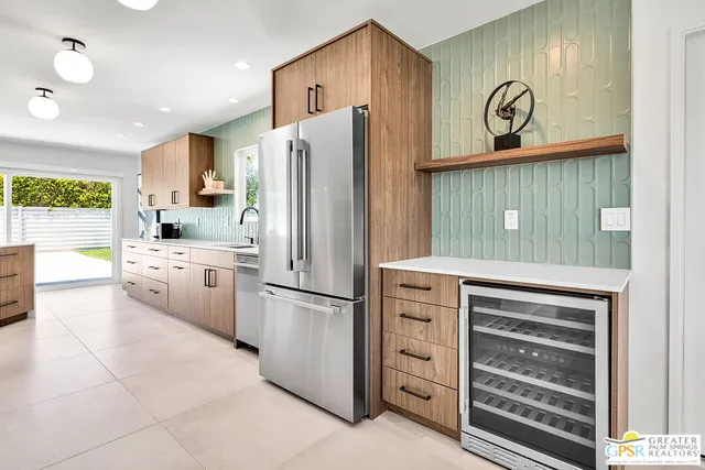 a kitchen with a refrigerator and a stove