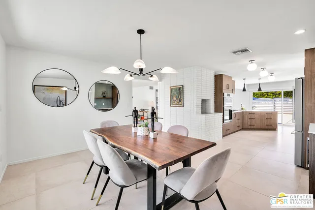a view of a dining room with furniture and chandelier